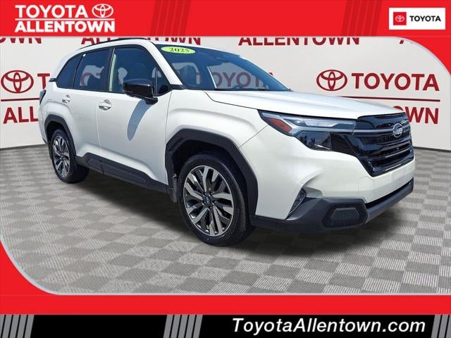 2025 Subaru Forester Touring in Crystal White Pearl — front three-quarter view